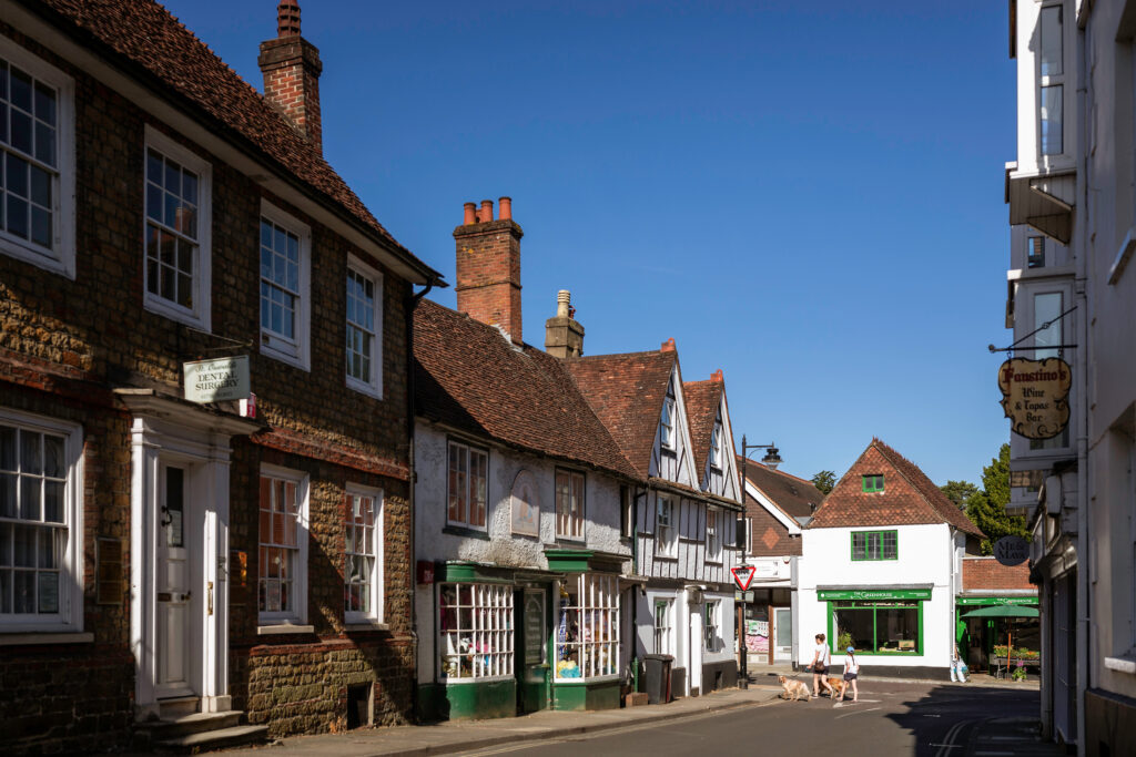A view looking down Knockhundred Row in Midhurst, Sussex with views of St. Oswald's Dental Surgery and The Greenhouse greengrocers.