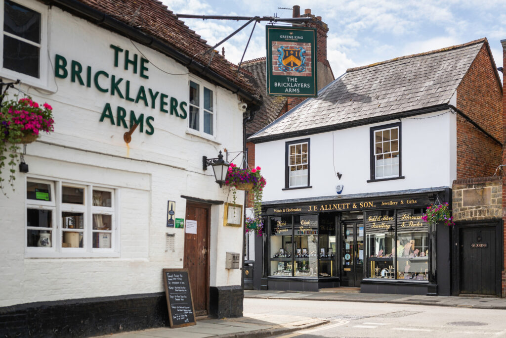 View of JE Allnutt & Son Jewellers opposite The Bricklayers Arms pub in West Street, Midhurst.