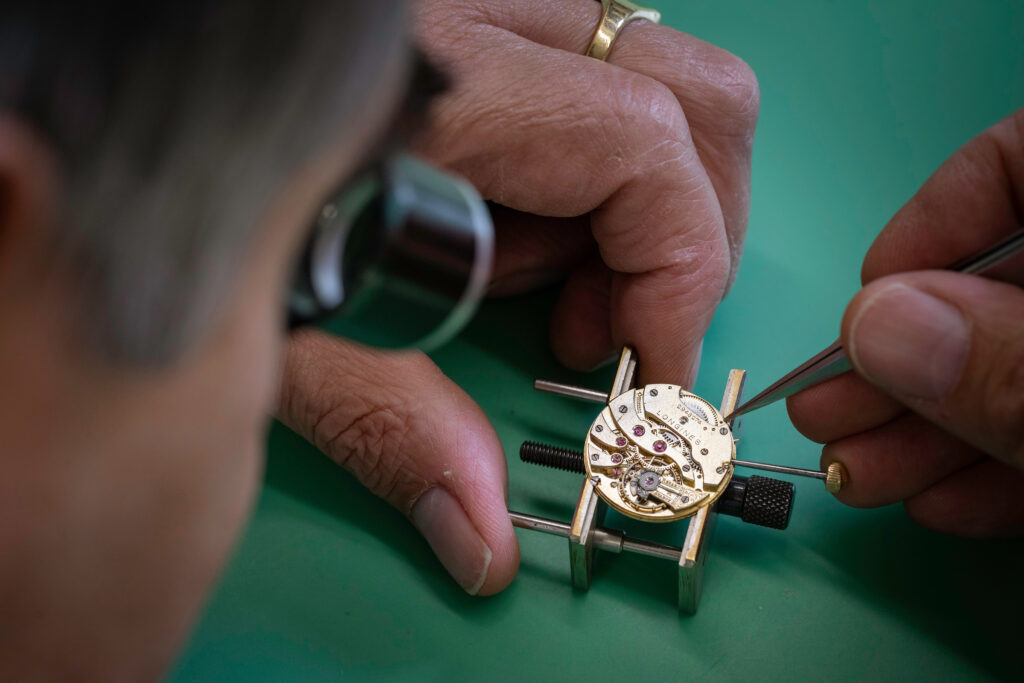 A closeup of Geoff Allnutt of JE Allnutt & Son repairing a watch at his shop in West Street, Midhurst, Sussex.