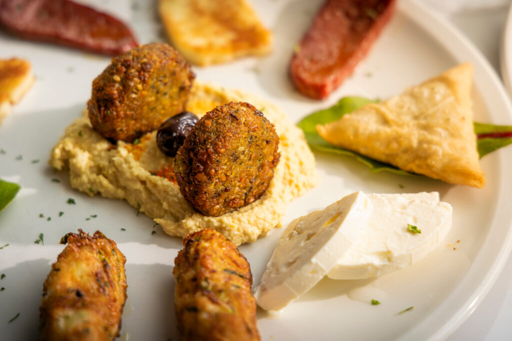 A closeup of hummus and falafel from Kemaellies cafe on North Street in Midhurst, West Sussex.