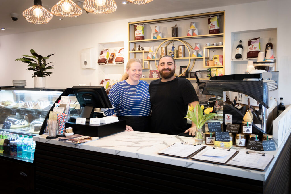 Staff members Ellie and Kemal of Kemaelli's cafe behind the counter in Midhurst.