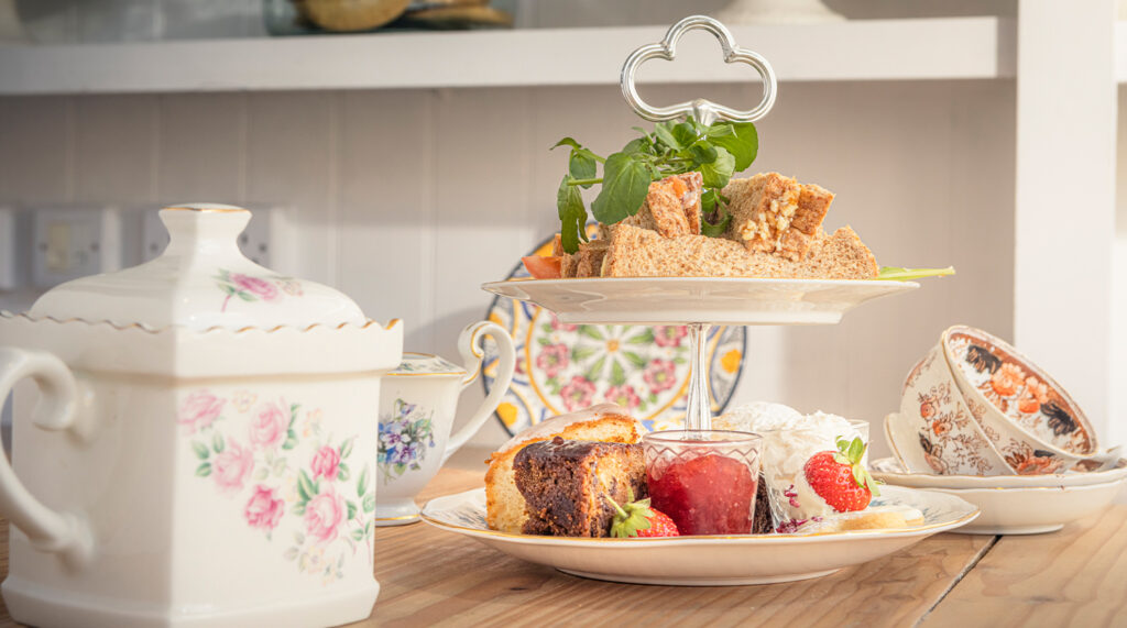 A closeup of cakes and a pot of tea at Tilly's Tea Room in Midhurst West Sussex.