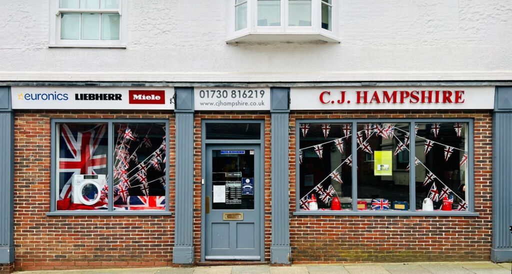 The exterior shop front of CJ Hampshire electrical good in Midhurst, West Sussex.