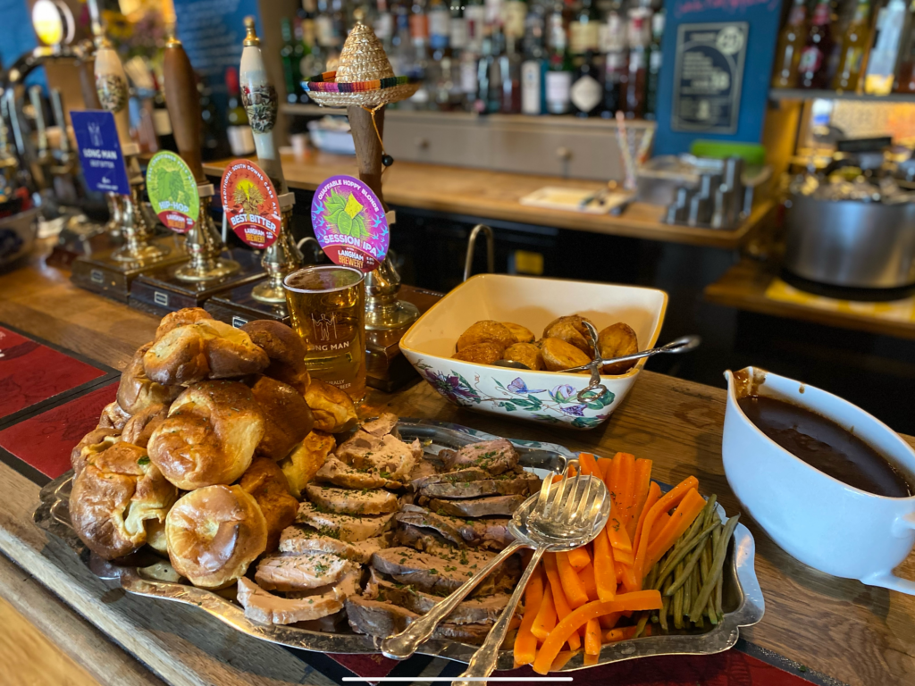 A silver tray filled with food for a Sunday roast on the bar counter at The Hollist Arms pub in West Sussex.