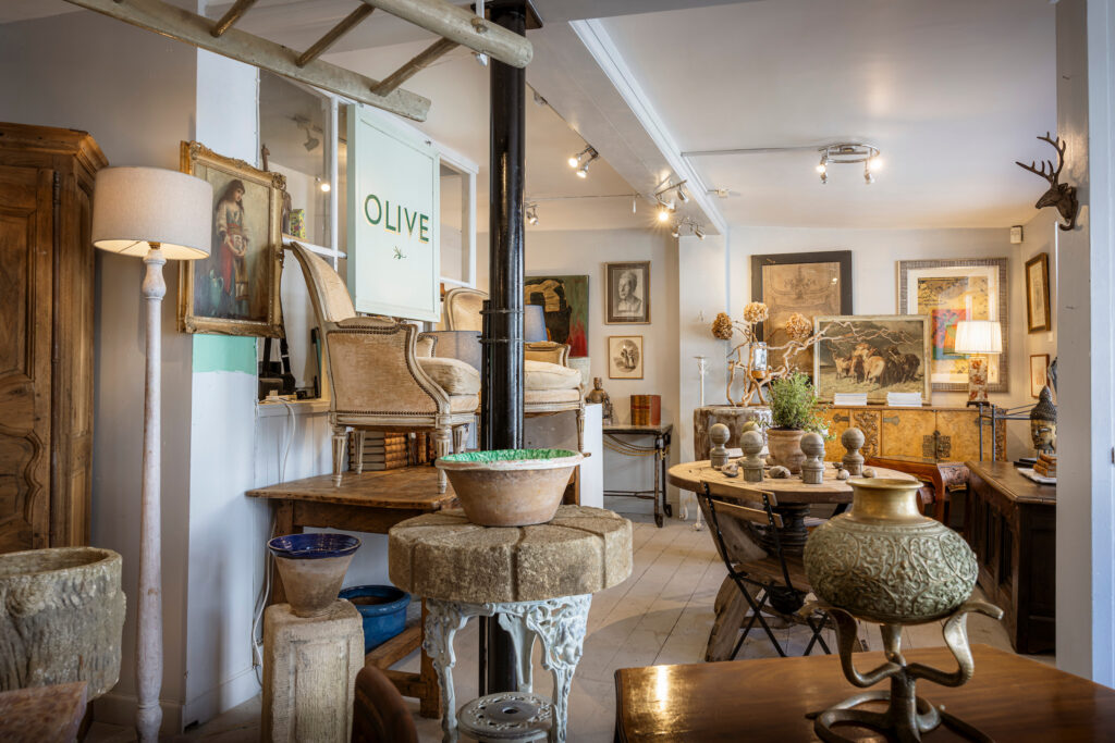 Inside Olive Interiors in Midhurst, showing country house style furniture, antiques, and stoneware.