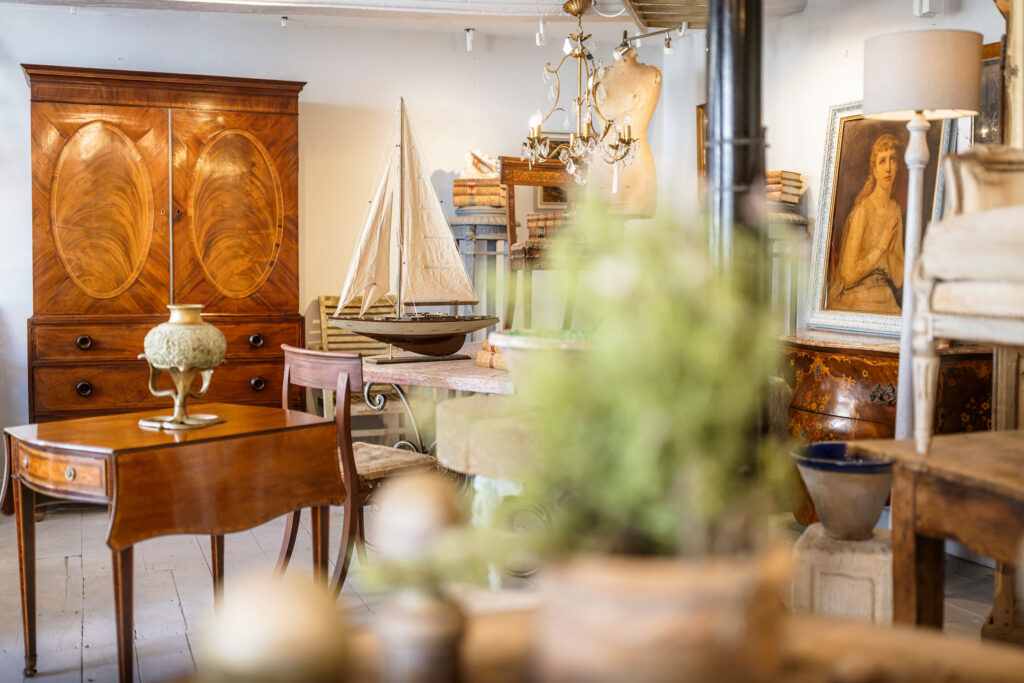 Inside Olive Interiors in Midhurst, showing period furniture and antiques.